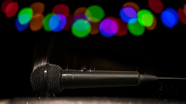 A microphone falling onto a stage floor.