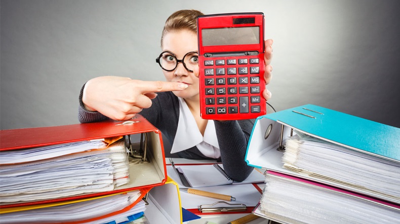 Calculations and results concept. Woman in office calculate company finance. Businesswoman with big red calculator in hand