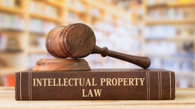 Intellectual Property law books and a gavel on desk in the library. concept of legal education.