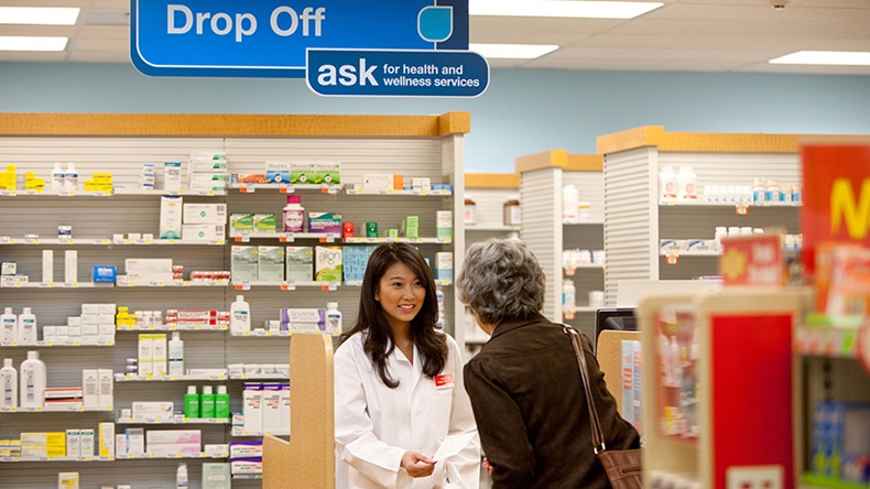 Female CVS retail pharmacist with patient