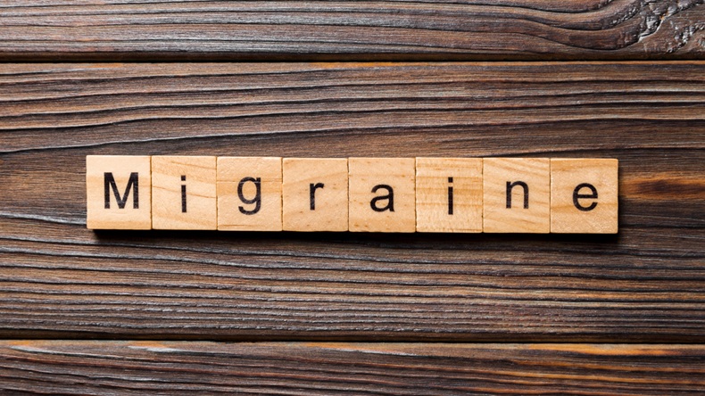 Migraine word written on wood block. Migraine text on wooden table for your desing, concept.