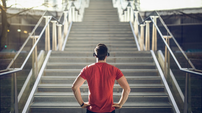 Man in red shirt preparing for stair run
