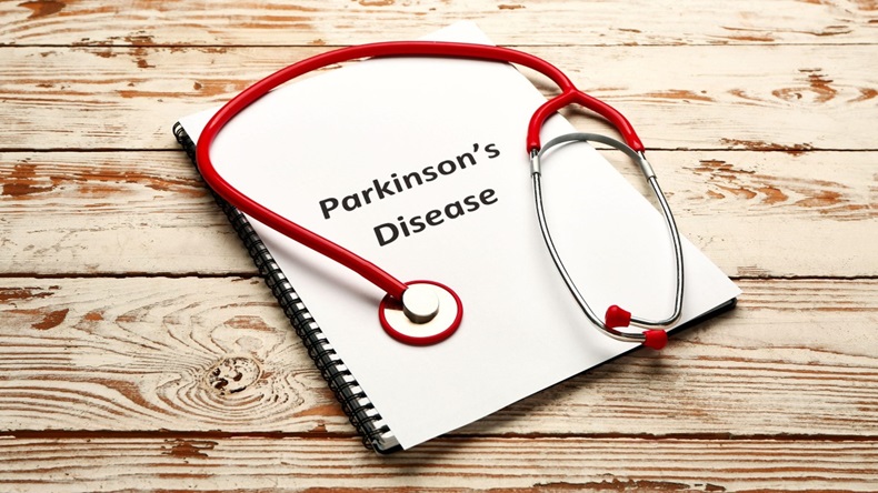 Notebook with PARKINSON'S DISEASE on white wooden background