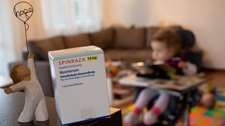 Box of Spinraza in the foreground, young child in the background