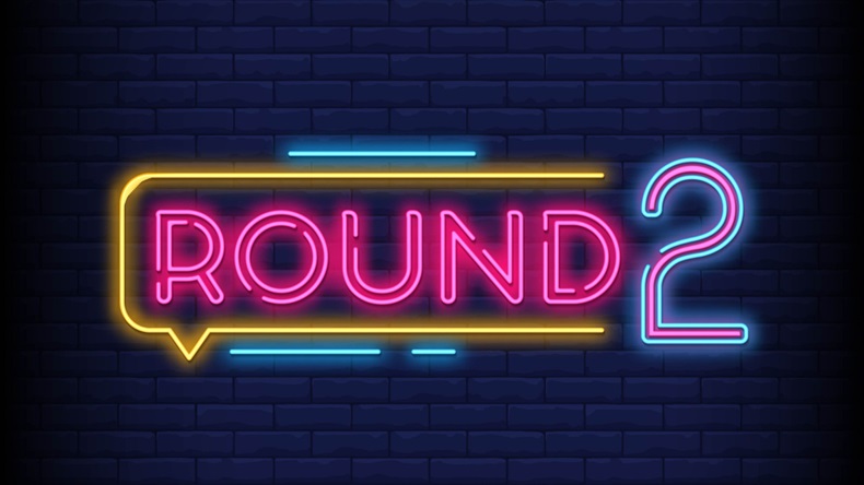 Round 2 neon sign with a Brick Wall Background