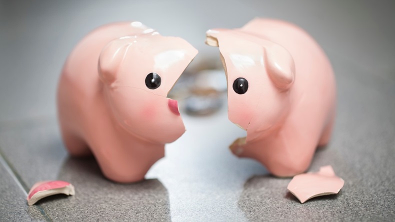 Broken piggy bank representing the use of cash savings in times of crisis, running out of money.