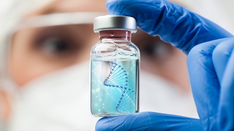 Woman holding up vial containing RNA strand