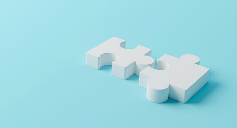 White jigsaw puzzle pieces connecting together on a light blue background