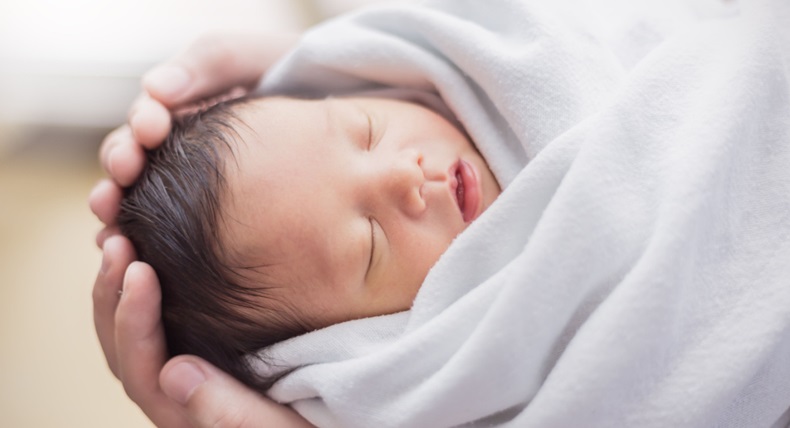 Portrait of asian parent hands holding newborn baby