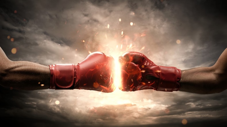 two fists in red box gloves about to hit each other