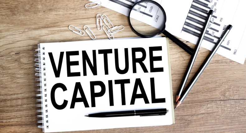 venture capital, text on white paper on wood background
