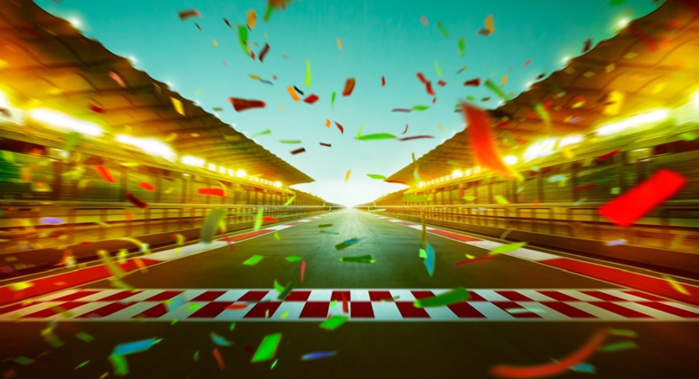 Night speedy motion blur international race track with starting finishing line and confetti