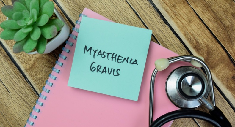 Concept of Myasthenia Gravis written on sticky notes isolated on Wooden Table.
