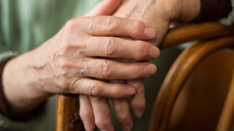  two hands of an elderly woman sitting on a chair - Image 